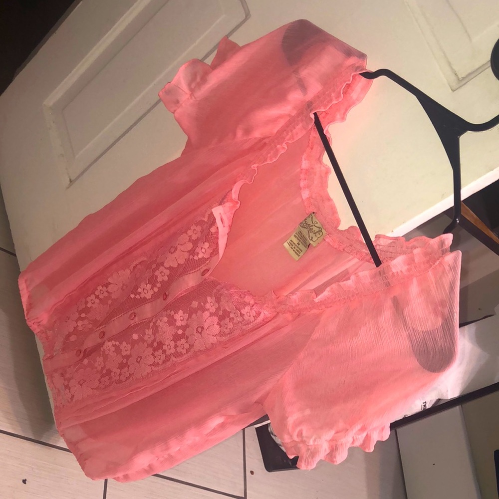 A pretty pink blouse with a beautiful flower sequence